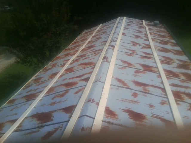 Rusted metal roof panels with new wood purlins before replacement — Storm Damage Roof Repair in Waterbury by Roofing Brothers